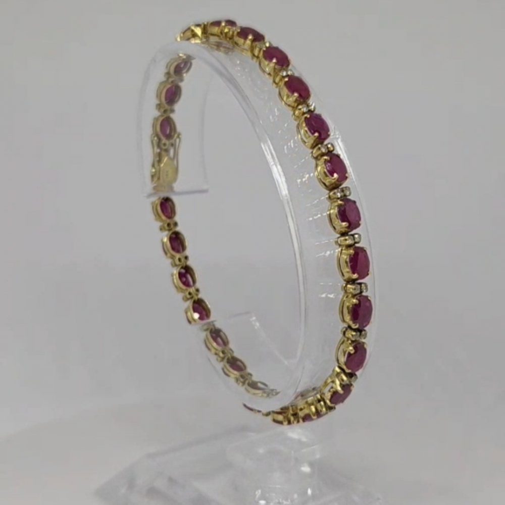 bracciale oro giallo 18k, modello tennis, con pietre rosse e diamantini